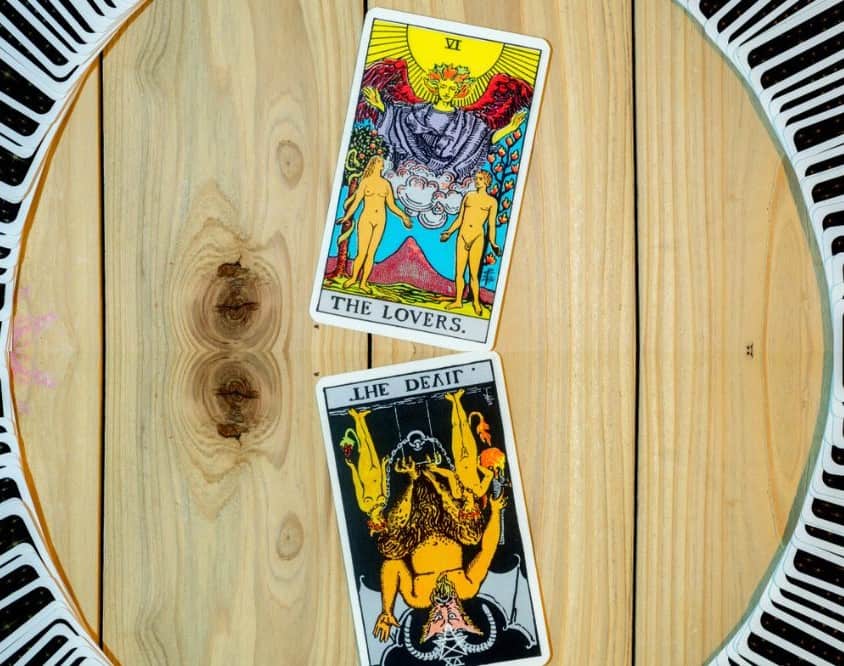 The Devil &Amp; The Lovers Tarot Card Combination On A Wooden Table